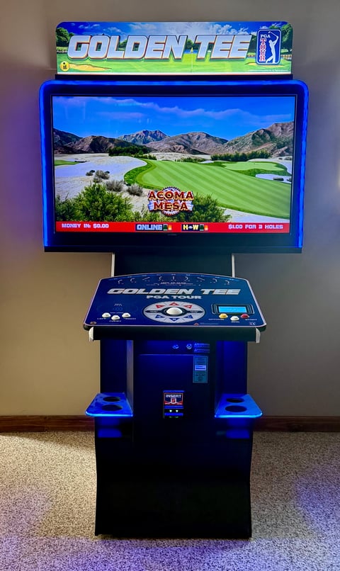 PGA Tour Golden Tee arcade game cabinet displaying golf course with blue cabinet and monitor mounted on stand